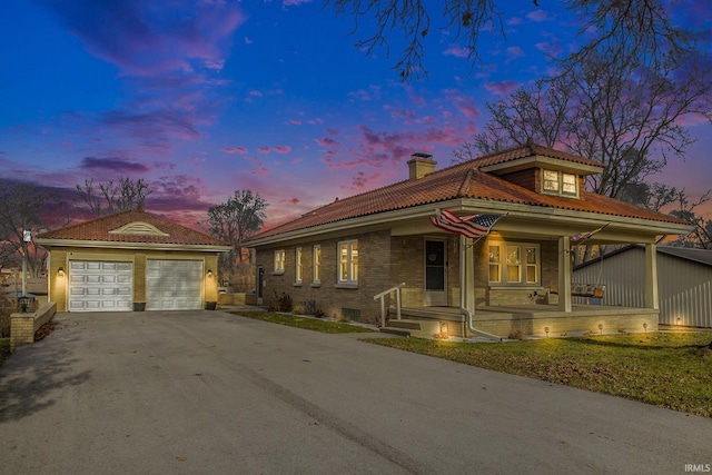 view of front of house featuring covered porch and a garage