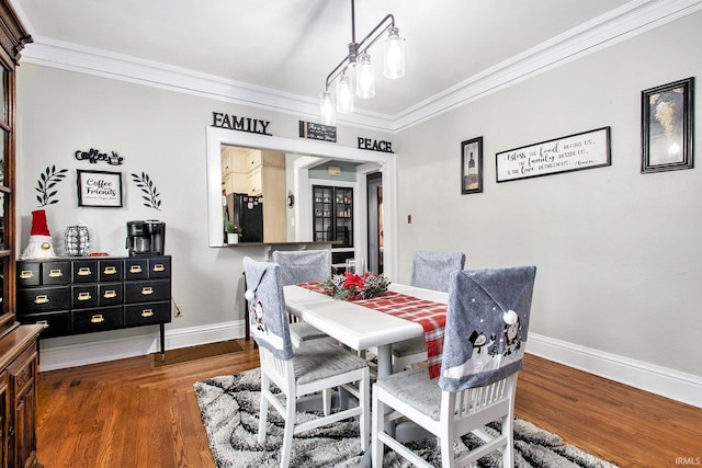 dining room with ornamental molding and dark wood-type flooring