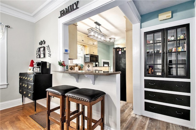 bar featuring dark hardwood / wood-style flooring, fridge, and crown molding