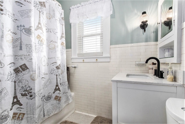 full bathroom featuring vanity, tile patterned floors, toilet, shower / bathtub combination with curtain, and tile walls