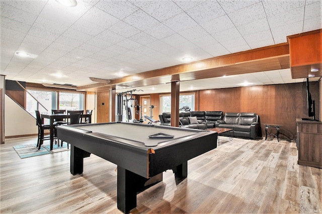 game room with wood walls, light wood-type flooring, and billiards