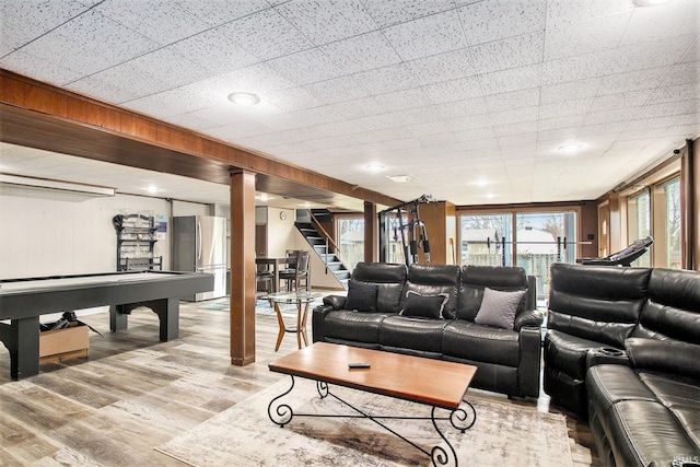 living room with wooden walls and light wood-type flooring