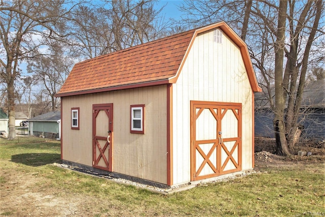 view of outbuilding featuring a lawn