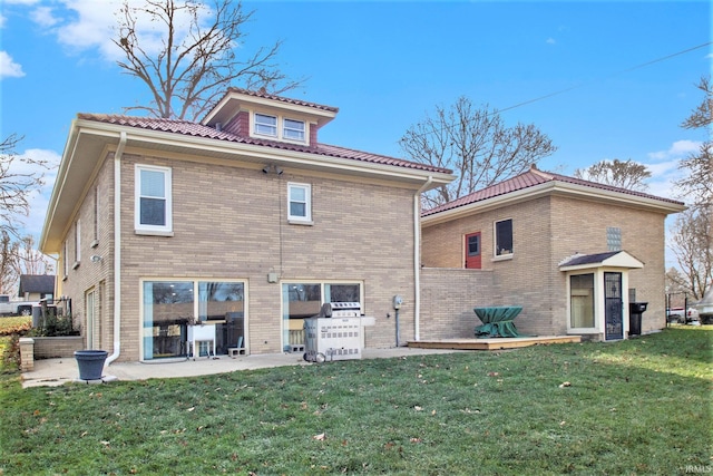 back of property featuring a patio area and a yard