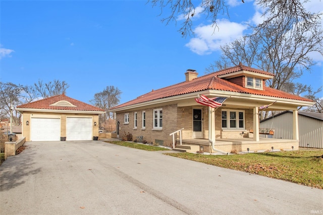 view of front of house with covered porch and a garage