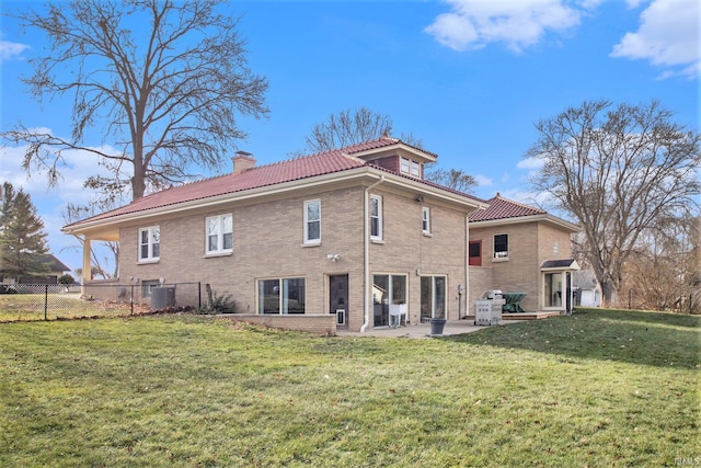 rear view of house with central air condition unit, a yard, and a patio