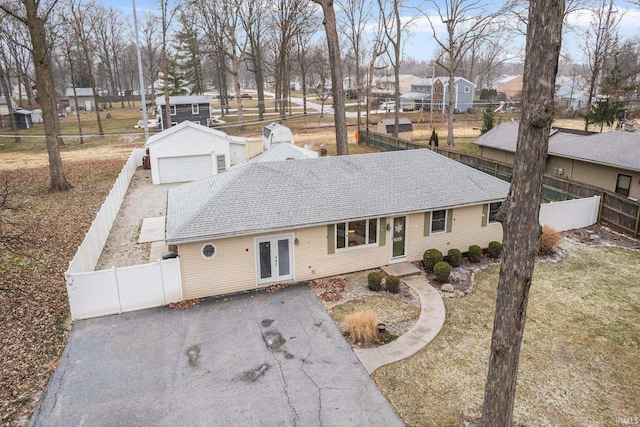 single story home with french doors and an outbuilding