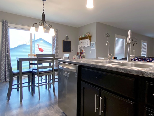 kitchen featuring dishwasher, sink, hardwood / wood-style floors, a chandelier, and decorative light fixtures