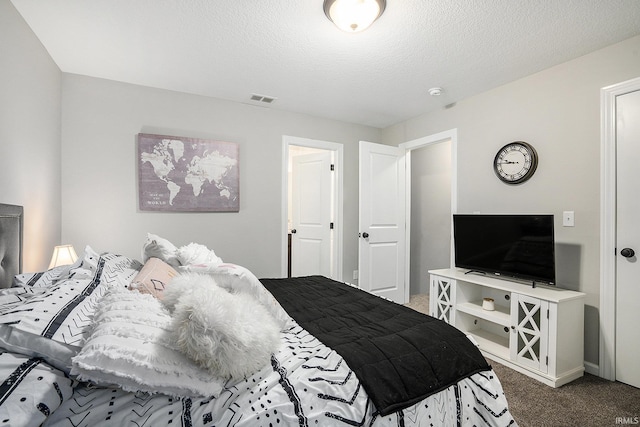 carpeted bedroom featuring a textured ceiling