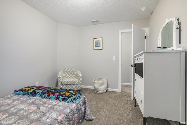 carpeted bedroom featuring a textured ceiling