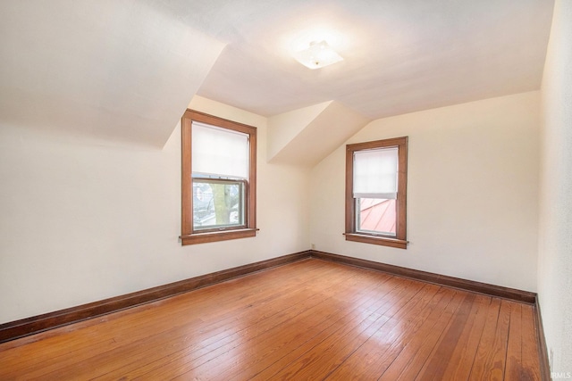 bonus room with vaulted ceiling and hardwood / wood-style flooring