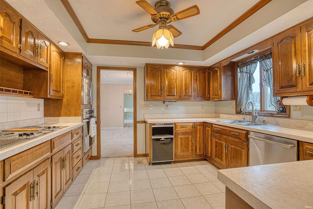 kitchen featuring appliances with stainless steel finishes, ornamental molding, ceiling fan, sink, and light tile patterned flooring