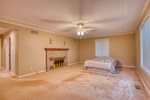 unfurnished bedroom featuring carpet flooring, ornamental molding, a textured ceiling, ceiling fan, and a fireplace