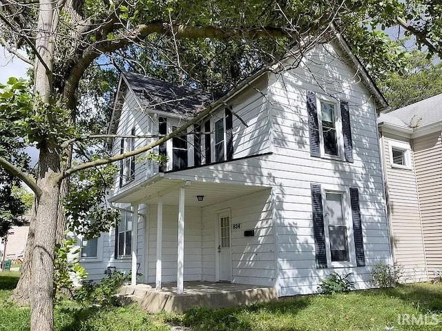 back of property with a porch