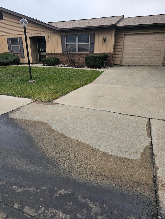 view of front of home featuring a garage and a front lawn