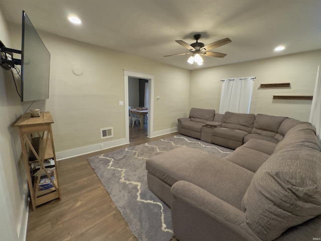 living room with ceiling fan and dark hardwood / wood-style flooring