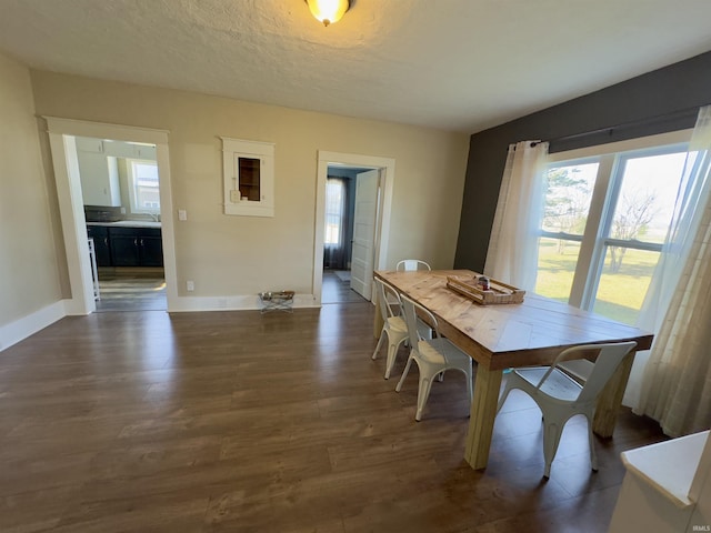 dining room with a textured ceiling, sink, and dark hardwood / wood-style floors