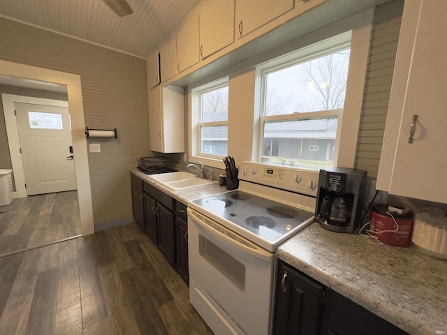 kitchen featuring wooden ceiling, dark wood-type flooring, white range with electric cooktop, white cabinets, and sink