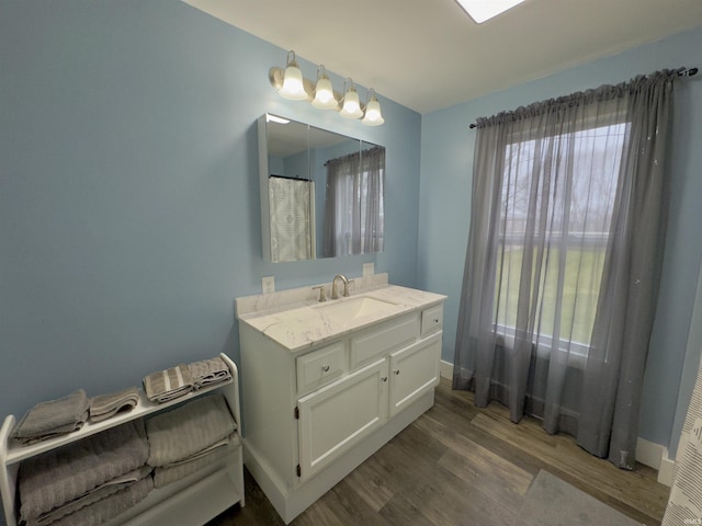 bathroom with hardwood / wood-style floors and vanity