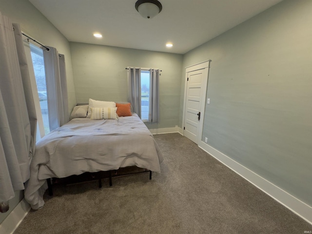 carpeted bedroom with multiple windows