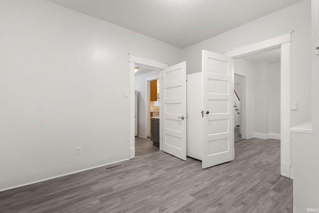 spare room with wood-type flooring