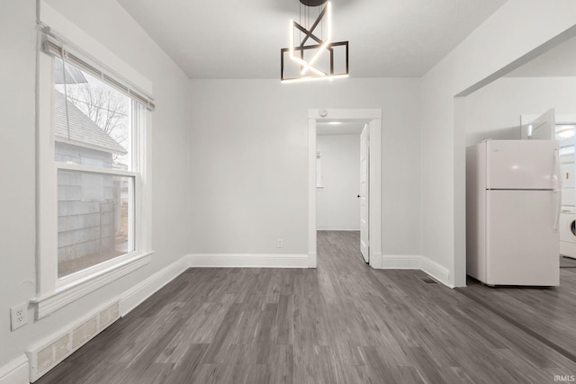 unfurnished dining area with dark hardwood / wood-style flooring and washer / clothes dryer