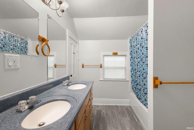 bathroom featuring hardwood / wood-style floors, vanity, and shower / bath combo with shower curtain