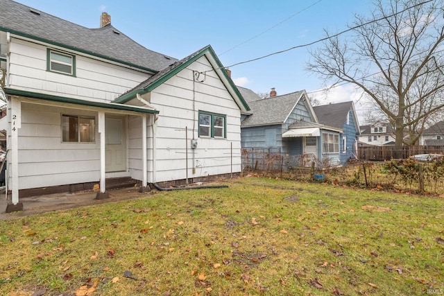 back of house with a lawn