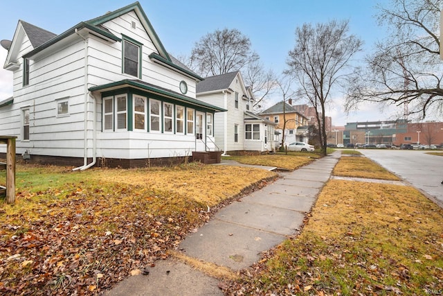 view of property exterior featuring a sunroom