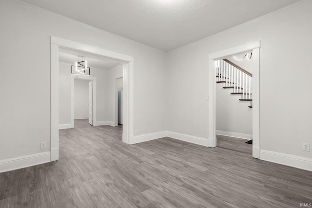 empty room featuring dark wood-type flooring and a textured ceiling