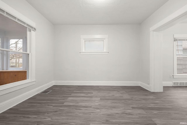 spare room with dark hardwood / wood-style floors