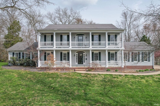 394 W Evergreen Plz, Santa Claus, IN 47579 - view of front of home featuring a porch, a balcony, a front lawn, and roof with shingles