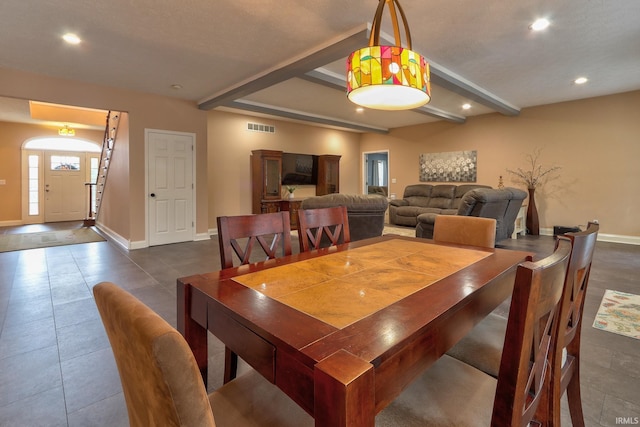 dining space featuring dark tile patterned flooring