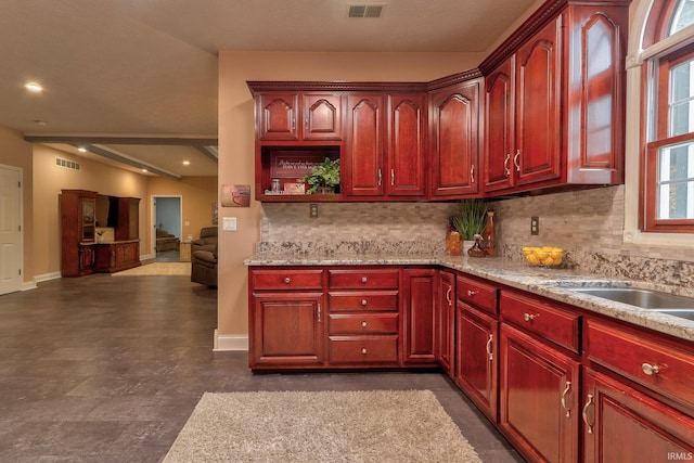 kitchen with light stone counters and backsplash