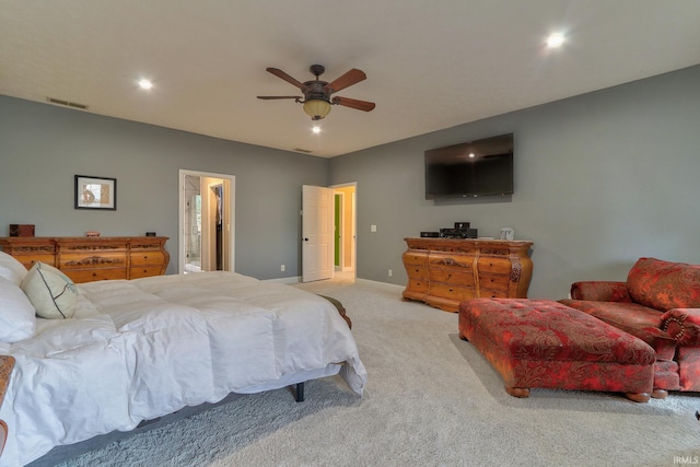 carpeted bedroom featuring ensuite bathroom and ceiling fan