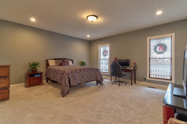 carpeted bedroom with a textured ceiling