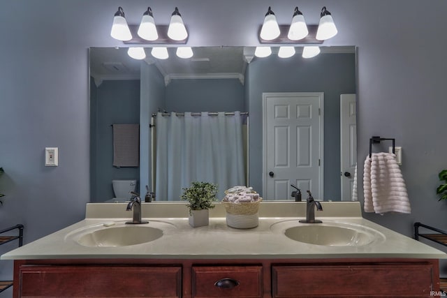 bathroom with vanity, toilet, crown molding, and walk in shower