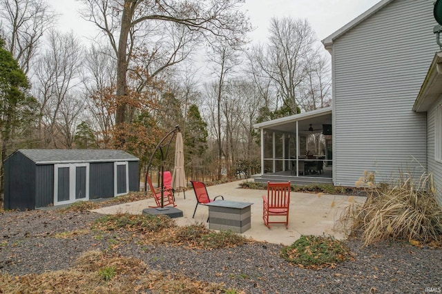 view of yard with a patio, a storage shed, and a sunroom