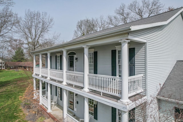 394 W Evergreen Plz, Santa Claus, IN 47579 - view of side of home featuring a balcony, a shingled roof, and covered porch