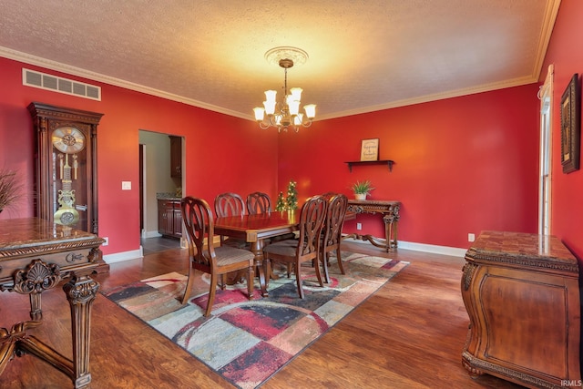 394 W Evergreen Plz, Santa Claus, IN 47579 - dining area featuring a chandelier, dark wood-type flooring, ornamental molding, and a textured ceiling
