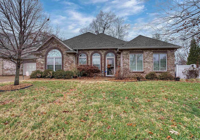 ranch-style house with a front yard and a garage