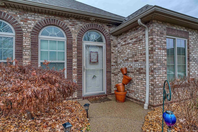 view of exterior entry featuring a patio area