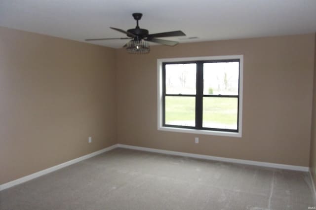 carpeted spare room with ceiling fan