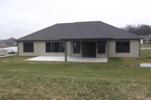 back of property with a lawn and a patio