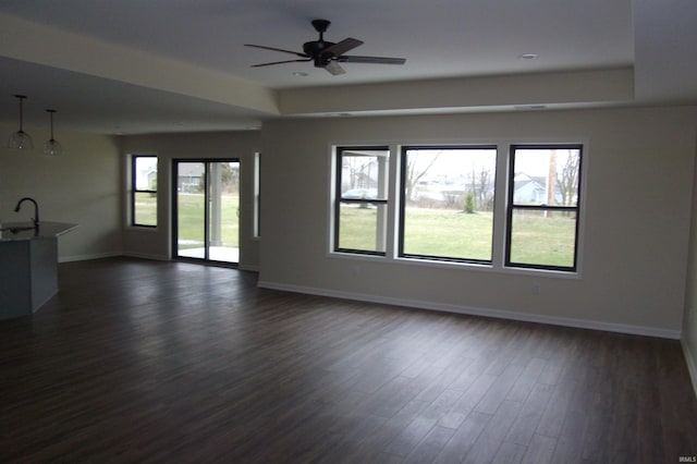 spare room with ceiling fan, dark hardwood / wood-style floors, plenty of natural light, and sink