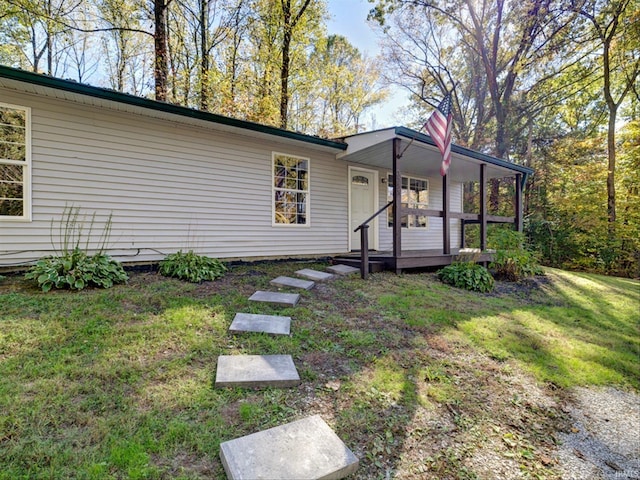 view of front of house with a front yard and a porch