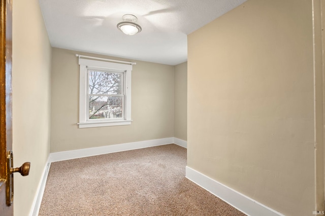 spare room with carpet flooring and a textured ceiling