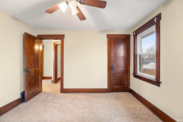 unfurnished bedroom featuring ceiling fan and light carpet