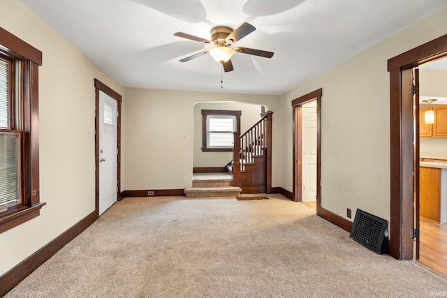 carpeted empty room with ceiling fan