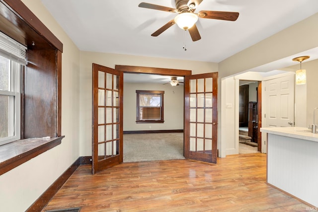 interior space featuring french doors, light hardwood / wood-style floors, and plenty of natural light